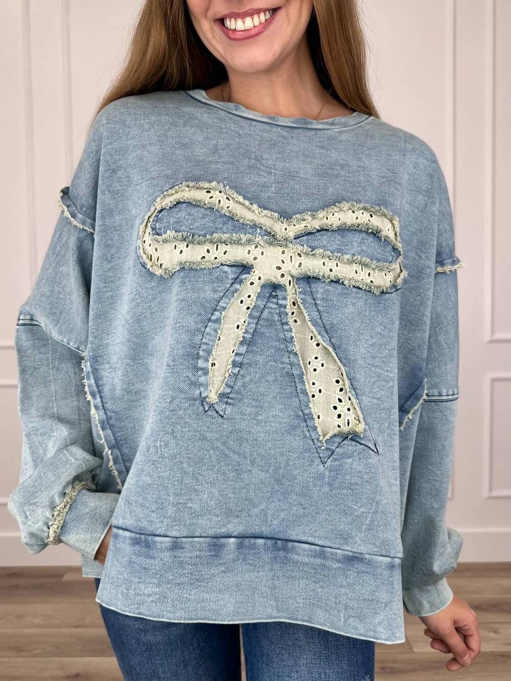 NEW HEIMISH USA eyelet bow applique raw edge sweatshirt in blue